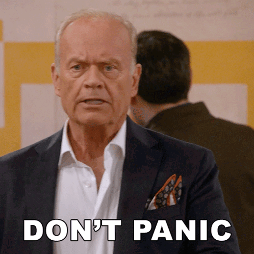A Man In A Suit Says " Don 'T Panic " GIF