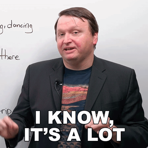 A Man In A Suit Says " I Know It 'S A Lot " In Front Of A White Board GIF