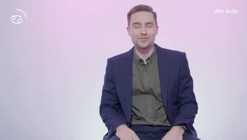 A Man In A Suit Says I 'M A Cancer On A Pink Background GIF