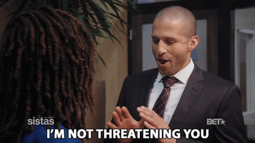 A Man In A Suit Says I 'M Not Threatening You To A Woman GIF