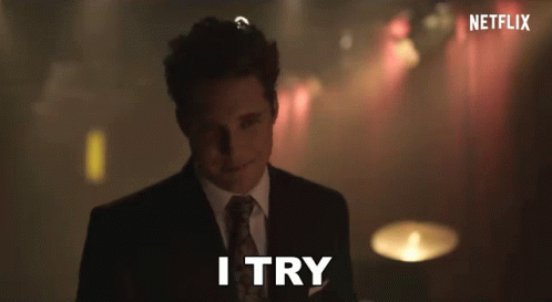 A Man In A Suit Says I Try In Front Of A Netflix Logo GIF