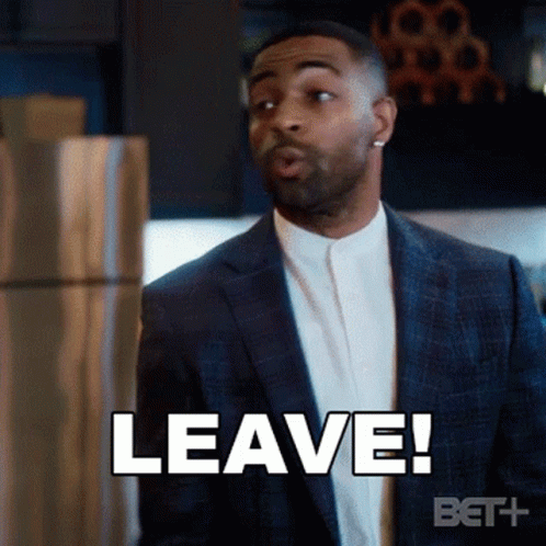 A Man In A Suit Says " Leave " While Standing In Front Of A Refrigerator GIF