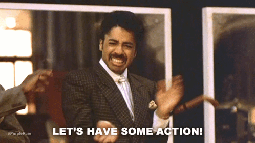 A Man In A Suit Says Let 'S Have Some Action While Dancing GIF