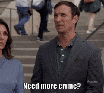 A Man In A Suit Says Need More Crime While Standing Next To A Woman GIF