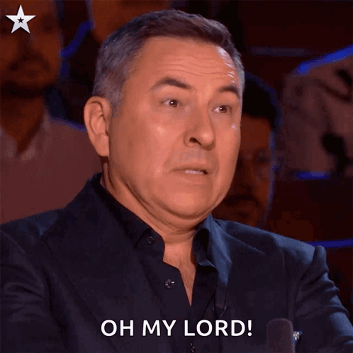 A Man In A Suit Says Oh My Lord With His Mouth Open GIF