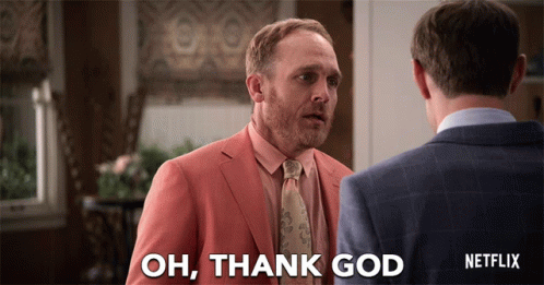 A Man In A Suit Says Oh Thank God GIF