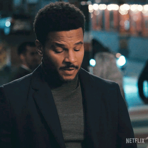 A Man In A Suit Says Okay In A Netflix Advertisement GIF