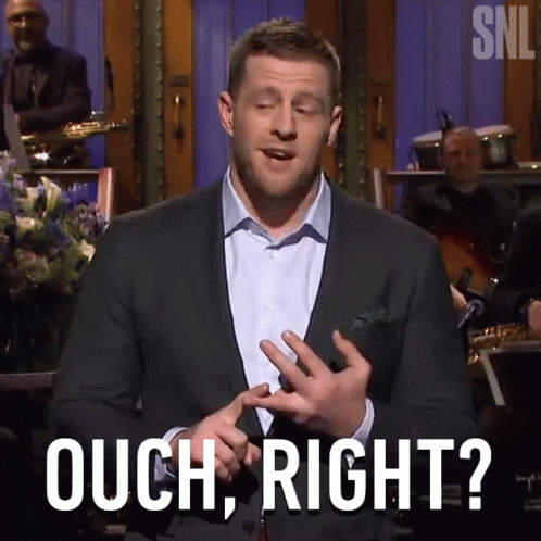 A Man In A Suit Says Ouch Right In Front Of A Band GIF