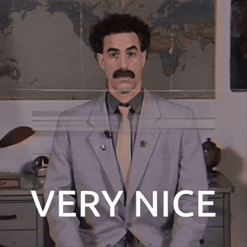 A Man In A Suit Says Very Nice In Front Of A Map GIF