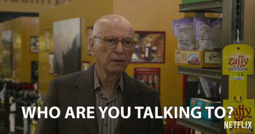 A Man In A Suit Says Who Are You Talking To In A Store GIF