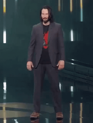 A Man In A Suit Says You 'Re Breathtaking While Standing On A Stage GIF