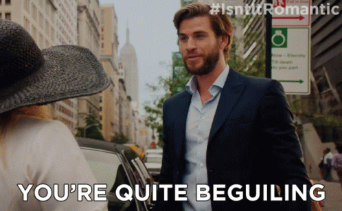 A Man In A Suit Says You 'Re Quite Beguiling To A Woman GIF