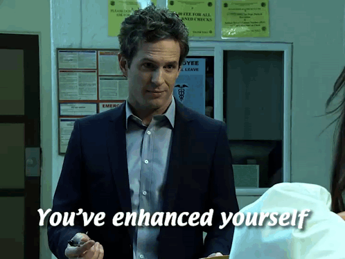 A Man In A Suit Says You 'Ve Enhanced Yourself In Front Of A Bulletin Board GIF