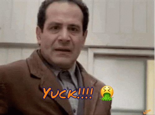 A Man In A Suit Says Yuck With A Smiley Face GIF