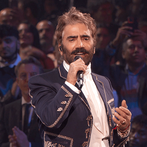 a man in a suit singing into a microphone
