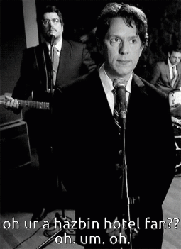 A Man In A Suit Singing Into A Microphone With The Words Oh Ur A Hazbin Hotel Fan Below Him GIF