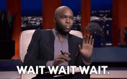 A Man In A Suit Sits In A Chair With The Words Wait Wait Wait Below Him GIF