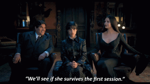 A Man In A Suit Sits Next To Two Women And Says " We 'Ll See If She Survives The First Session " In Front Of Them GIF