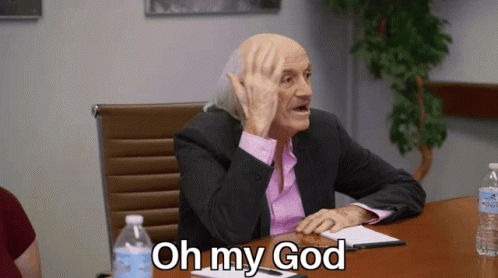 Man In Suit Sitting At Table With Oh My God GIF