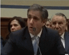 A Man In A Suit Speaking Into A Microphone GIF