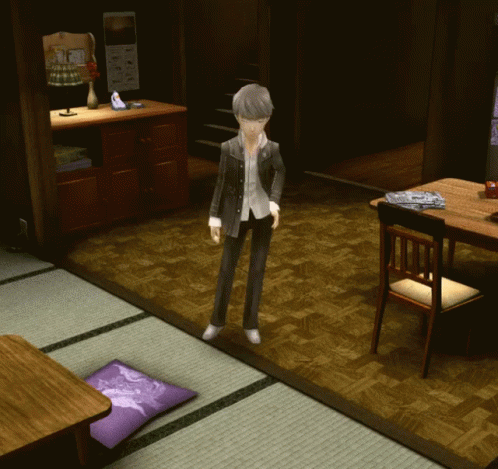 A Man In A Suit Stands In A Living Room With A Purple Pillow On The Floor GIF
