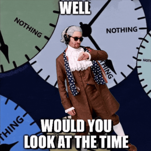 A Man In A Suit Stands In Front Of A Clock With The Words Well Would You Look At The Time GIF