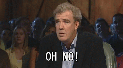 A Man In A Suit Stands In Front Of A Crowd And Says Anyway GIF