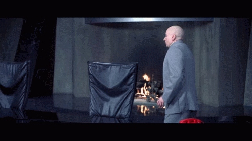 A Man In A Suit Stands In Front Of A Fireplace With The Words There 'S Nothing More Pathetic Than An Aging Hipster GIF