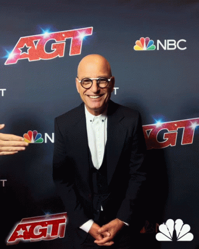 A Man In A Suit Stands In Front Of A Nbc Ad GIF
