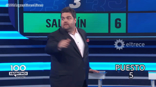 A Man In A Suit Stands In Front Of A Screen That Says 100 Argentinas Dicen GIF