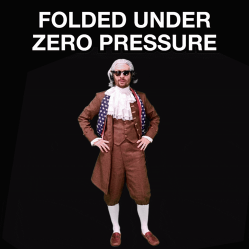 A Man In A Suit Stands In Front Of A Sign That Says " Folded Under Zero Pressure " GIF