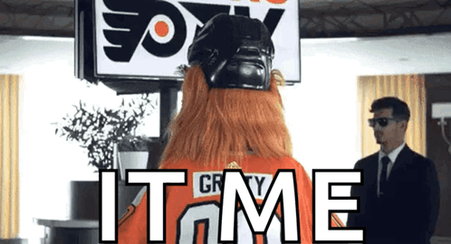 A Man In A Suit Stands In Front Of A Sign That Says " Fox " GIF