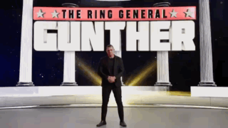 A Man In A Suit Stands In Front Of A Sign That Says Gunther GIF