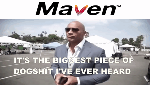 a man in a suit stands in front of a sign that says " maven "