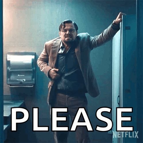 a man in a suit stands in front of a sign that says please on it
