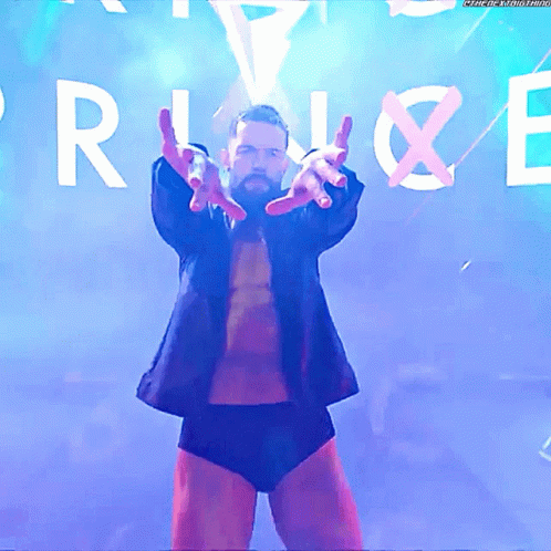 A Man In A Suit Stands In Front Of A Sign That Says " Rise " GIF