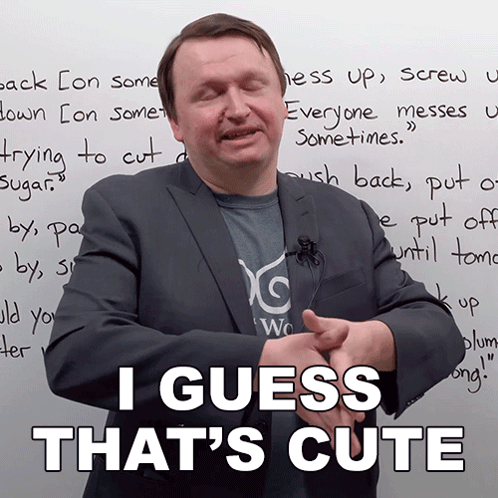 A Man In A Suit Stands In Front Of A White Board That Says " I Guess That 'S Cute " GIF