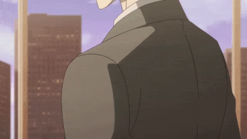 A Man In A Suit Stands In Front Of A Window With A City In The Background GIF