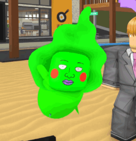 A Man In A Suit Stands Next To A Green Character GIF