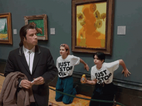 A Man In A Suit Stands Next To Two Children Wearing Shirts That Say Just Stop Oil GIF