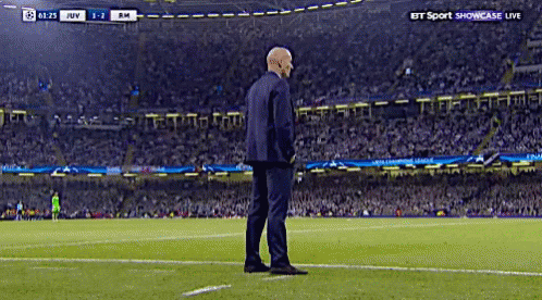A Man In A Suit Stands On A Soccer Field During A Bt Sport Showcase Live Match GIF
