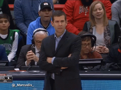 A Man In A Suit Stands With His Arms Crossed In Front Of A Screen That Says @ Marcusd2 GIF