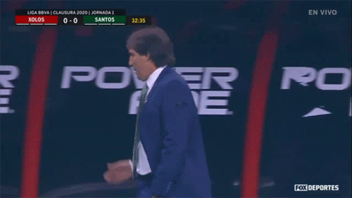 A Man In A Suit Talks On A Cell Phone In Front Of A Power Ad Sign GIF