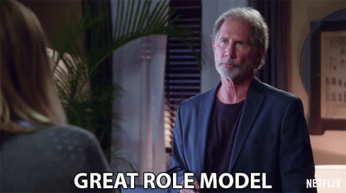 a man in a suit talks to a woman and says " great role model "