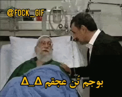 A Man In A Suit Talks To An Elderly Man In A Hospital Bed GIF