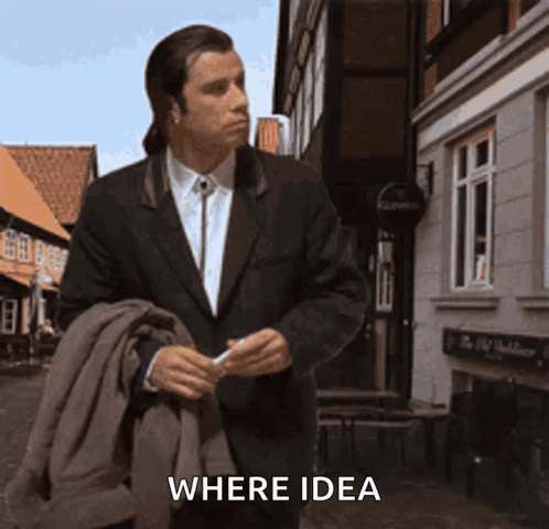 A Man In A Suit Walking Down A Street With The Word Where Idea Written On The Bottom GIF