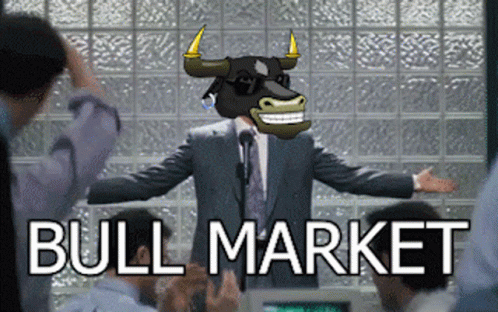 A Man In A Suit With A Bull On His Head Stands In Front Of A Group Of People With The Words Bull Market Behind Him GIF