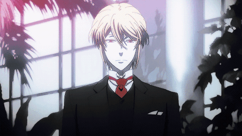 A Man In A Suit With A Red Tie Stands In Front Of A Window GIF