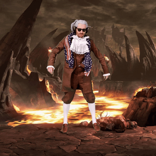 A Man In A Suit With An American Flag Scarf Around His Neck Stands In Front Of A Volcano GIF