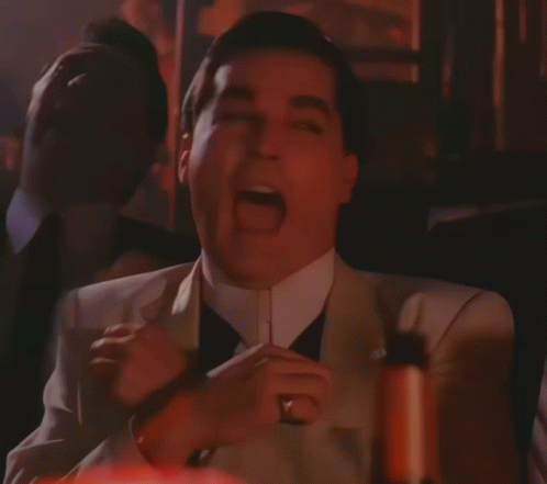 A Man In A Suit With His Mouth Open GIF